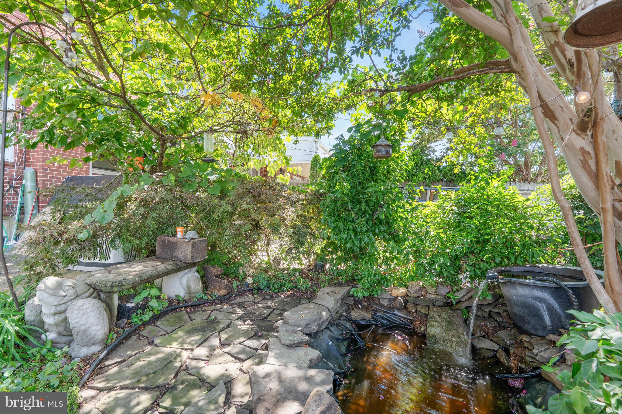 3454 McShane Way Baltimore, MD 21222 - Photo 24 of 35 a backyard of a house with large trees and plants