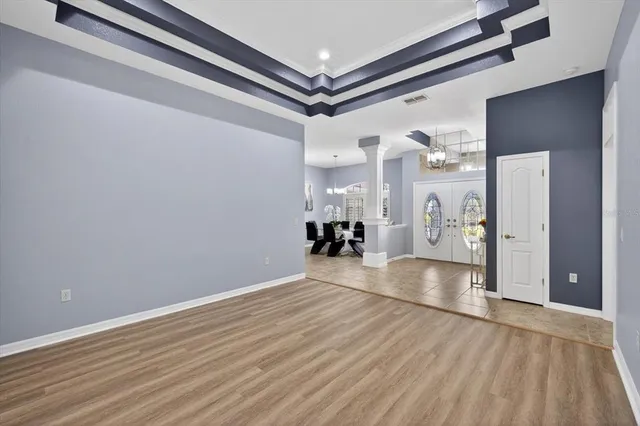 a bedroom with a bed and a flat tv screen on dresser