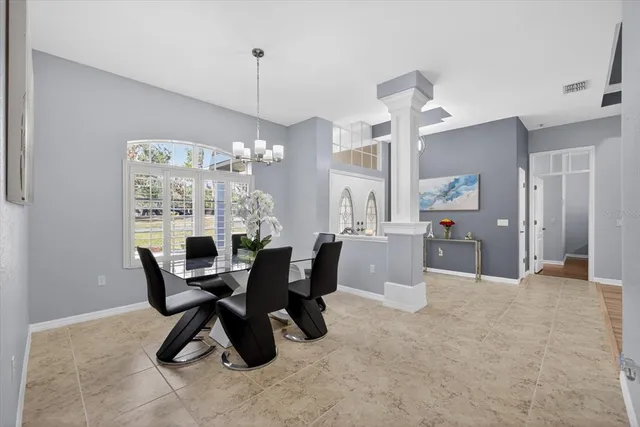a living room with fireplace furniture and a large window