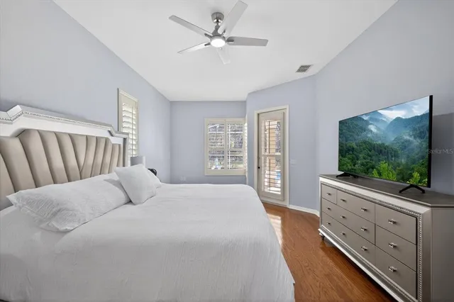 a large spacious bathroom with a tub a sink and a large mirror