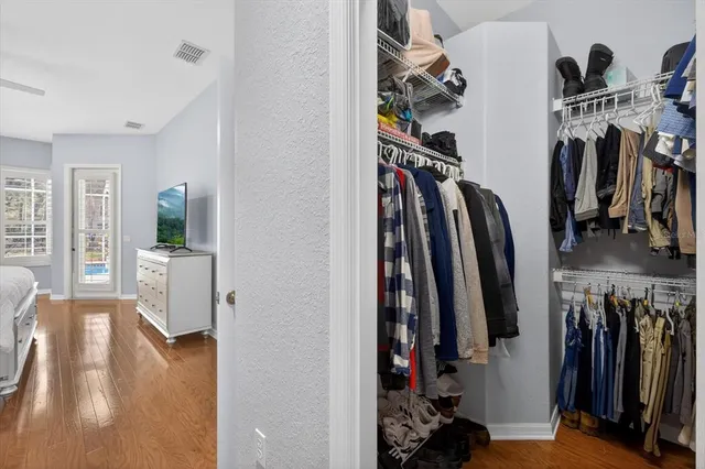 a very nice looking open dining room with kitchen island furniture a large window and a sink