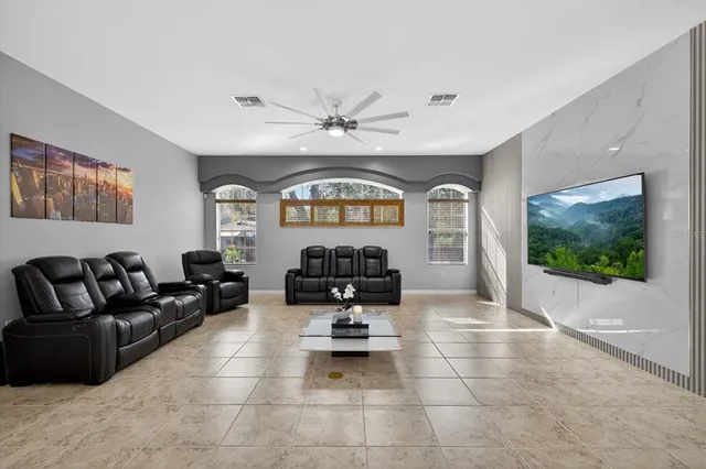 an aerial view of residential houses with outdoor space and trees