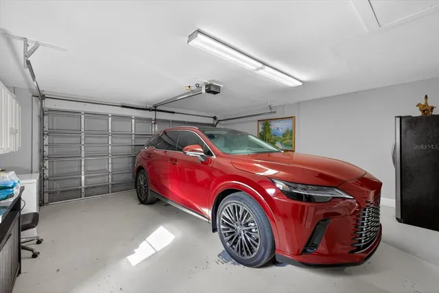 an aerial view of residential house with outdoor space and trees all around