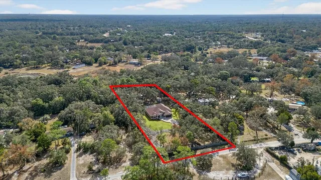 a view of a house with a yard and sitting area