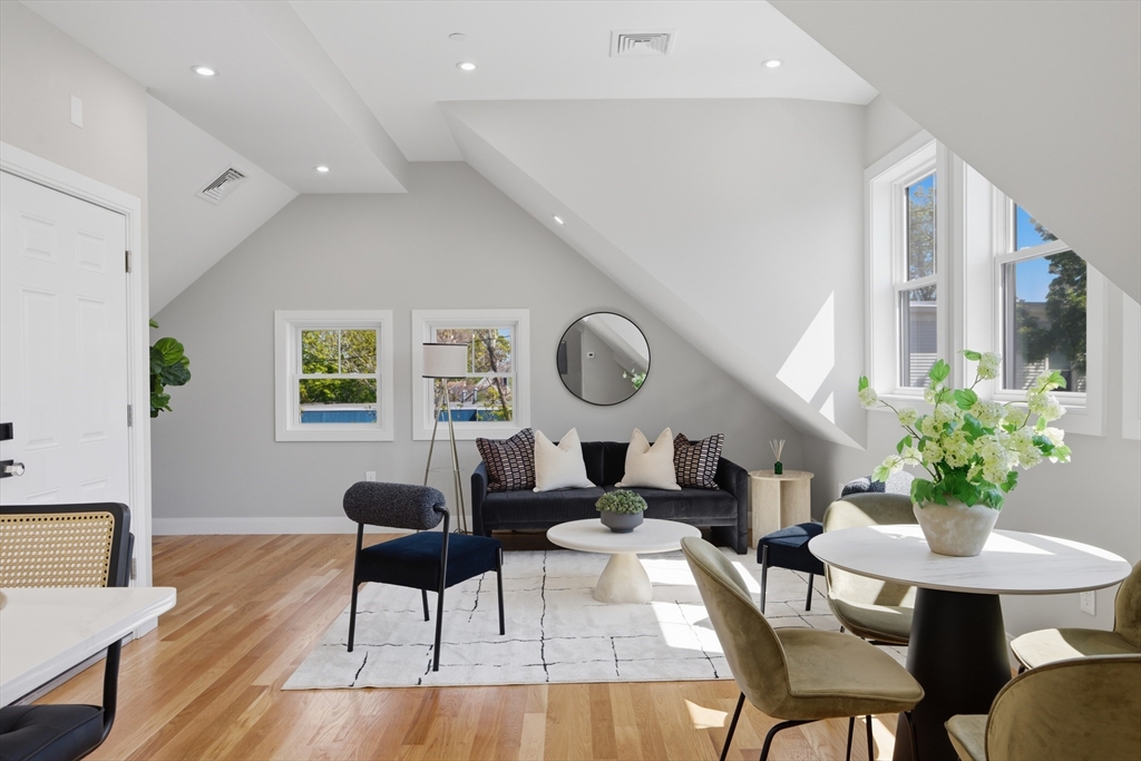 174 Walnut Street, Unit 3 Somerville, MA 02145 - Photo 21 of 38 a living room with furniture a potted plant and a large window