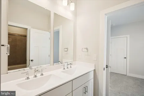 a bathroom with a sink double vanity and a mirror