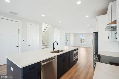 a kitchen with a sink refrigerator and a sink