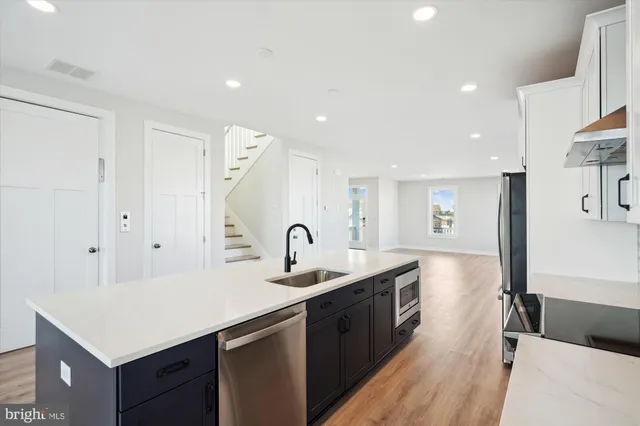a kitchen with a sink refrigerator and a sink