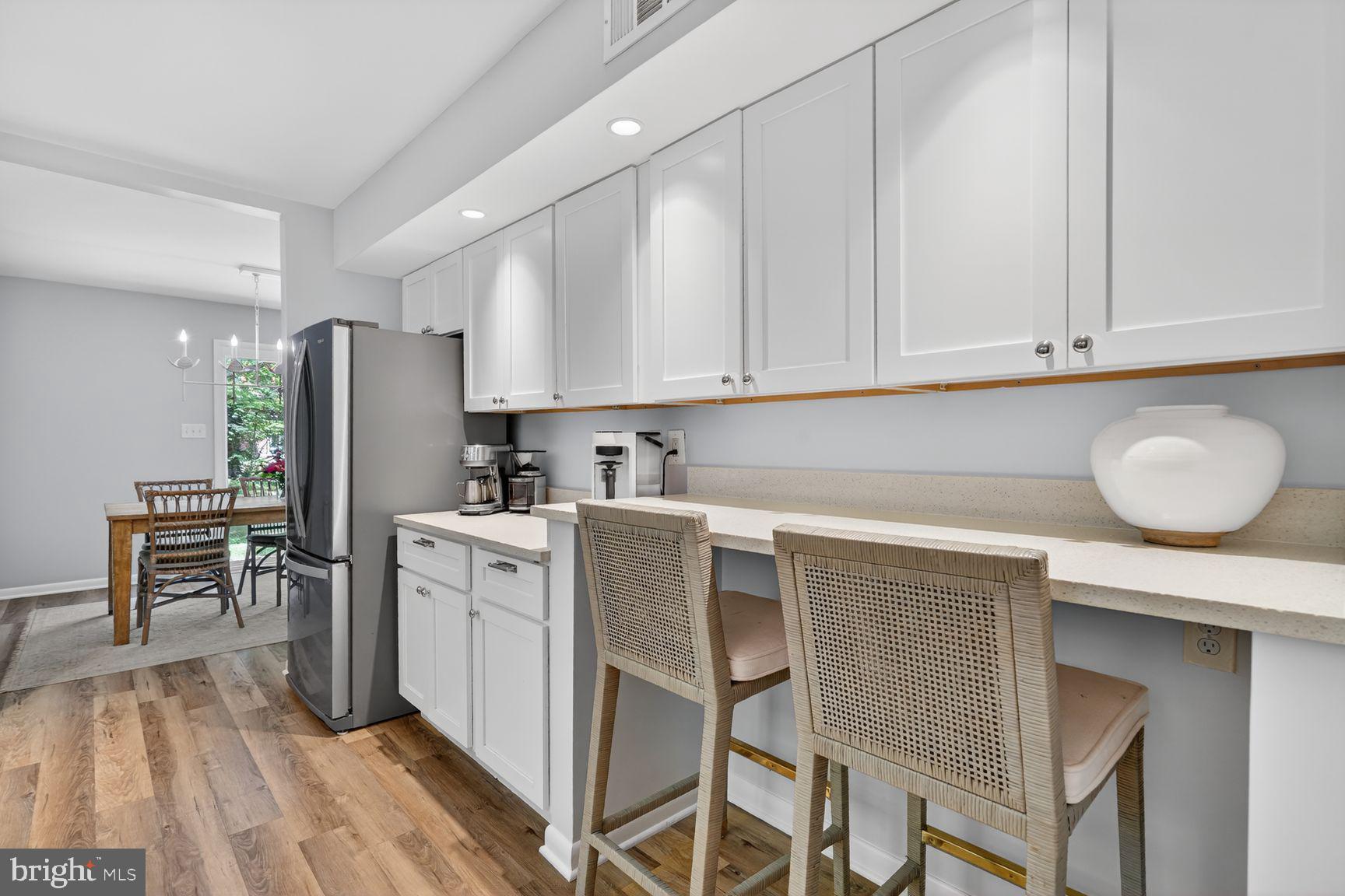 11201 Wedge Drive Reston, VA 20190 - Photo 9 of 31 a kitchen with a refrigerator a stove cabinets and wooden floor