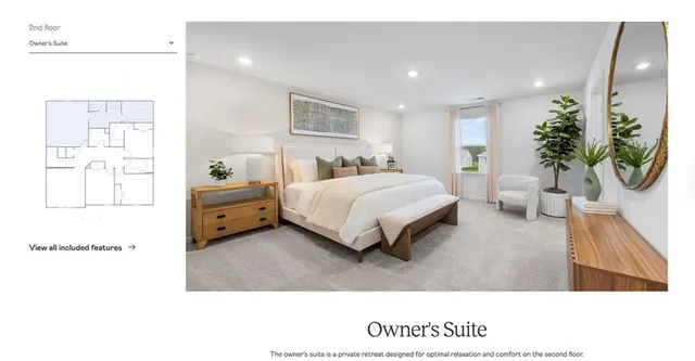 a bedroom with a bed mirror and vanity