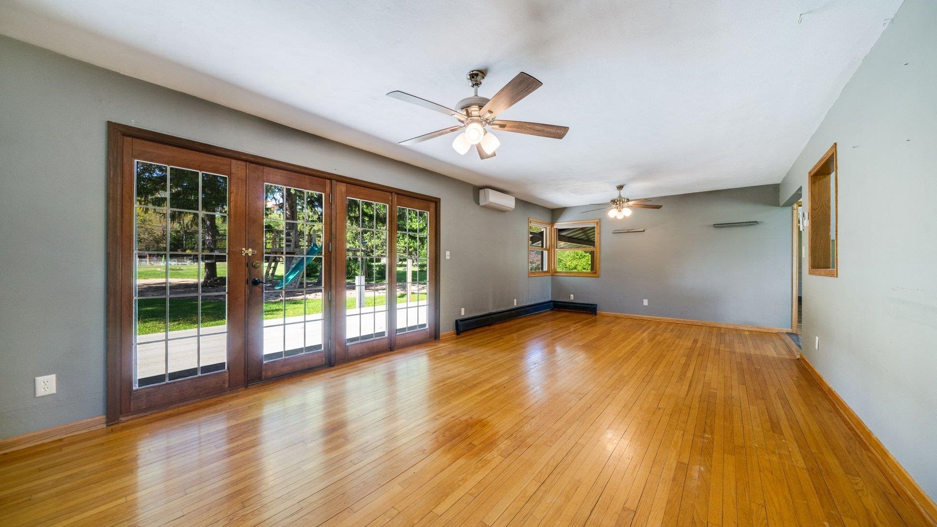313 West Margaret Fuller Road Oregon, IL 61061 - Photo 13 of 46 a view of an empty room with window and wooden floor