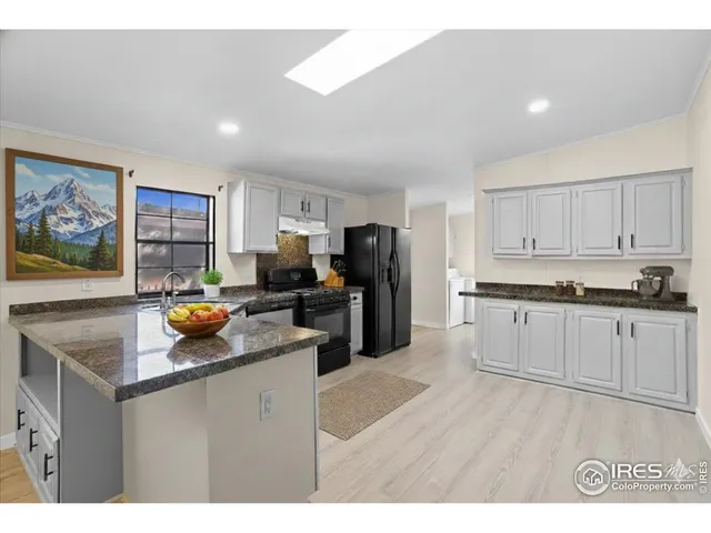 a kitchen with a refrigerator and a stove top oven