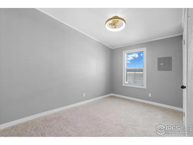 a living room with furniture and a baby crib