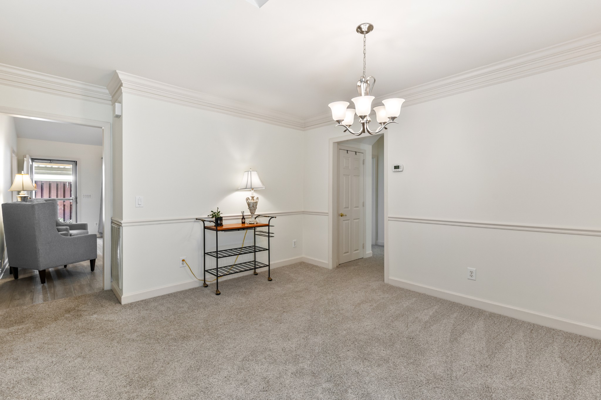 8090 Sunrise Circle Franklin, TN 37067 - Photo 12 of 57 a living room with furniture and a chandelier