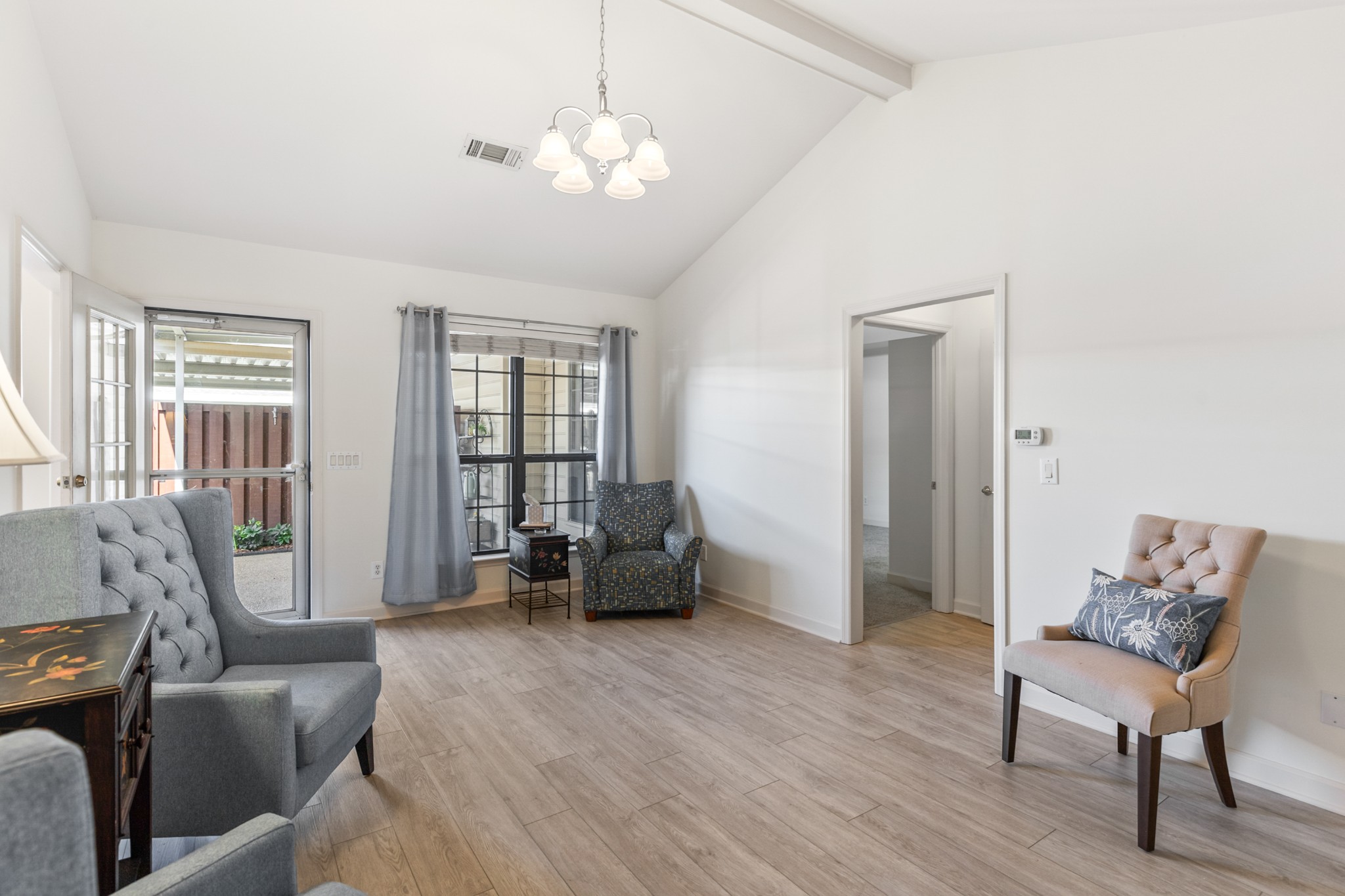 8090 Sunrise Circle Franklin, TN 37067 - Photo 15 of 57 a living room with furniture and a chandelier