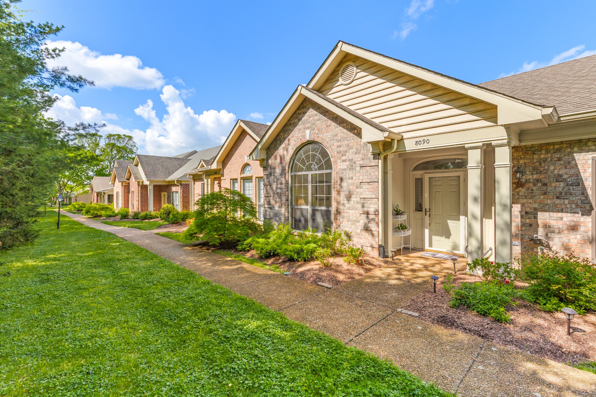 8090 Sunrise Circle Franklin, TN 37067 - Photo 2 of 57 a front view of a house with garden
