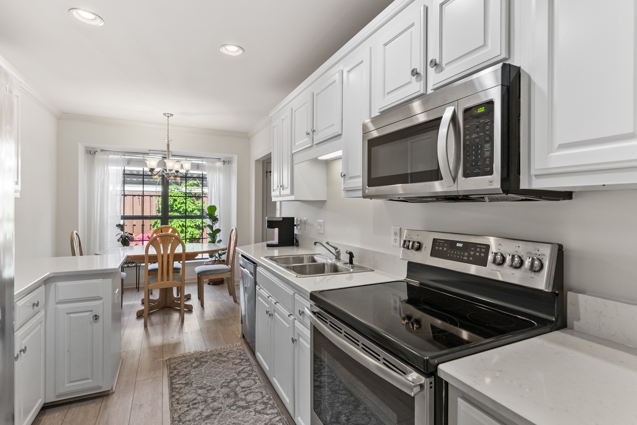 8090 Sunrise Circle Franklin, TN 37067 - Photo 21 of 57 a kitchen with a stove a sink and a microwave
