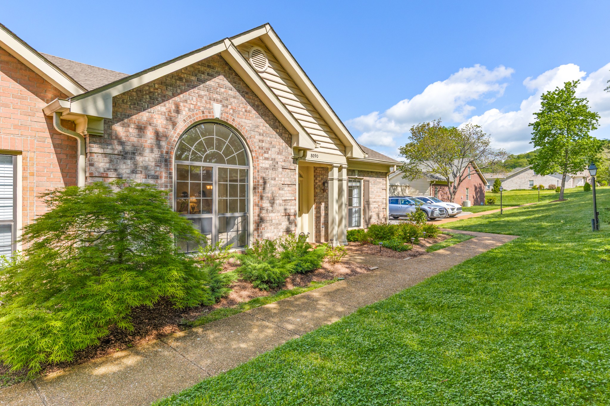 8090 Sunrise Circle Franklin, TN 37067 - Photo 3 of 57 a front view of a house with garden