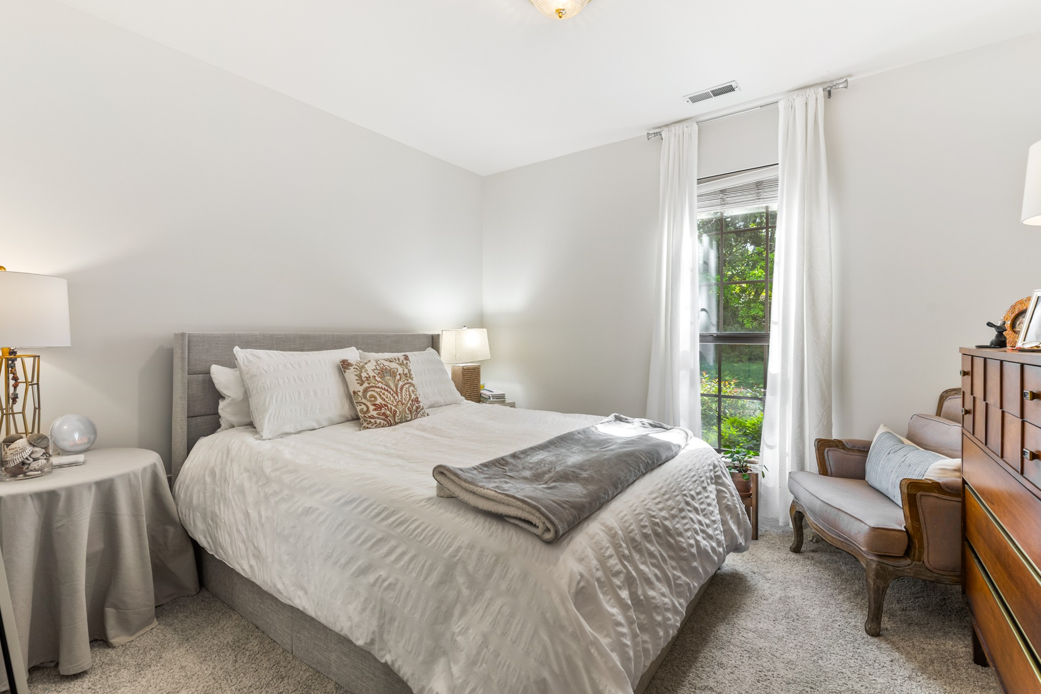 8090 Sunrise Circle Franklin, TN 37067 - Photo 34 of 57 a bedroom with a bed and a couch next to a window