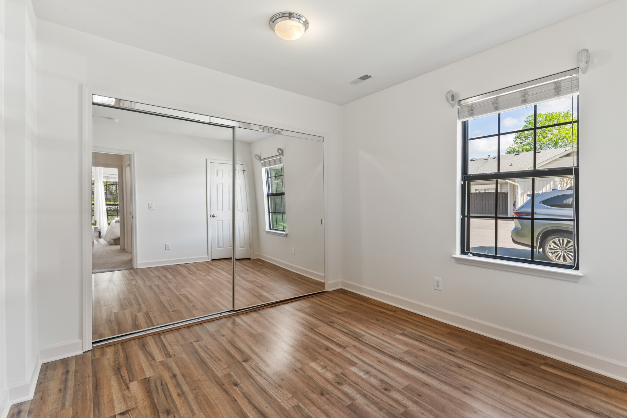 8090 Sunrise Circle Franklin, TN 37067 - Photo 39 of 57 an empty room with wooden floor and windows