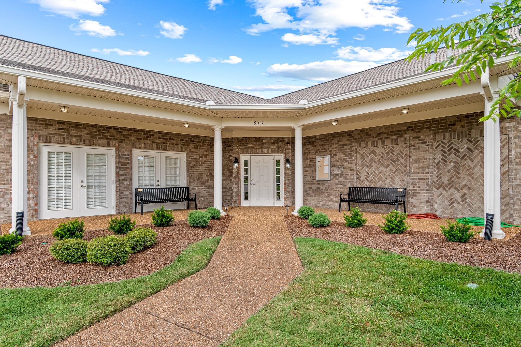 8090 Sunrise Circle Franklin, TN 37067 - Photo 51 of 57 a front view of a house with a yard and potted plants