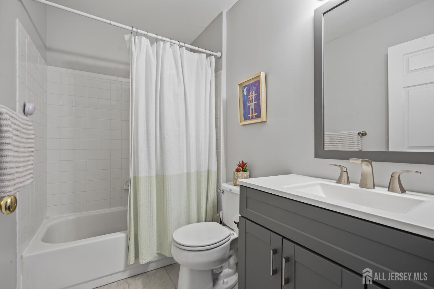 157 Setter Place Freehold, NJ 07728 - Photo 15 of 21 a bathroom with a sink a toilet and a bathtub