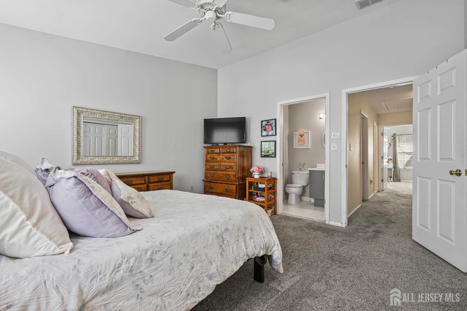 157 Setter Place Freehold, NJ 07728 - Photo 17 of 21 a bedroom with a bed and a flat tv screen