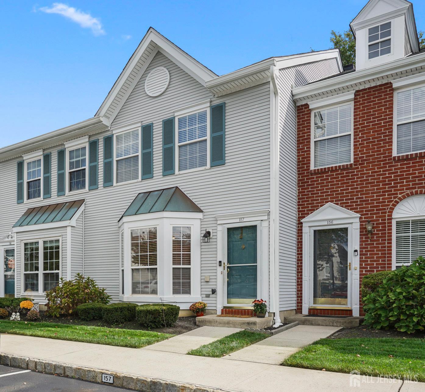 157 Setter Place Freehold, NJ 07728 - Photo 2 of 21 a front view of a house with garden and garage