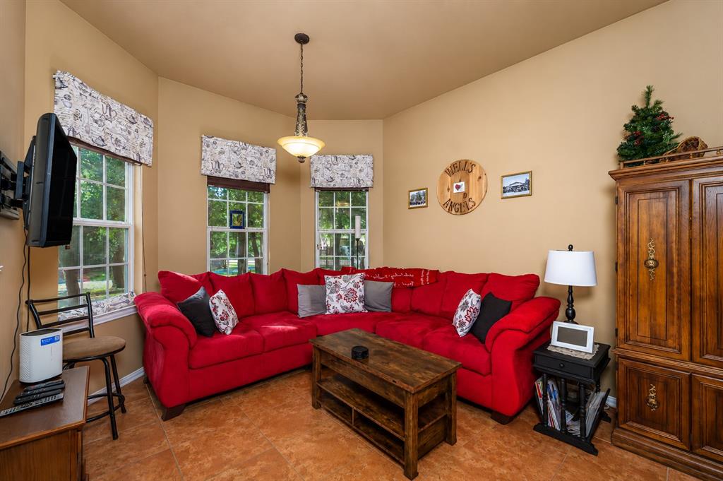 100 Manders Court Runaway Bay, TX 76426 - Photo 19 of 33 a living room with furniture and a chandelier