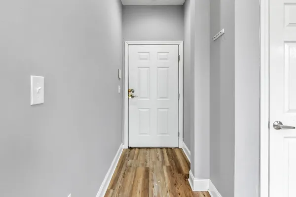 a view of a hallway with wooden floor
