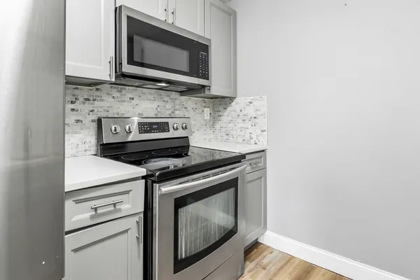 a stove top oven sitting inside of a kitchen