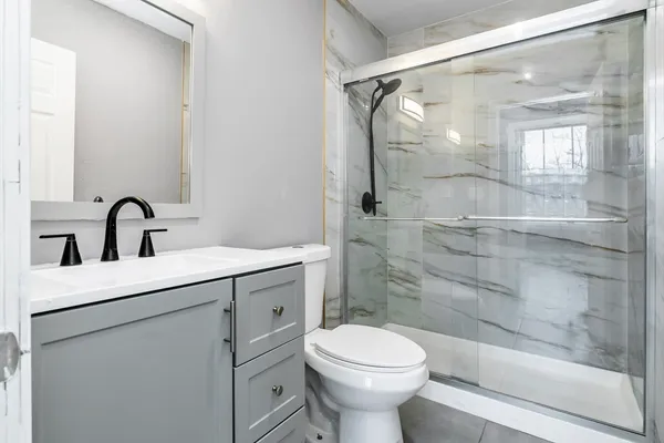 a bathroom with a sink toilet and shower