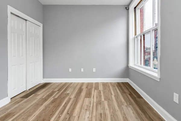 a view of a room with wooden floor and fan