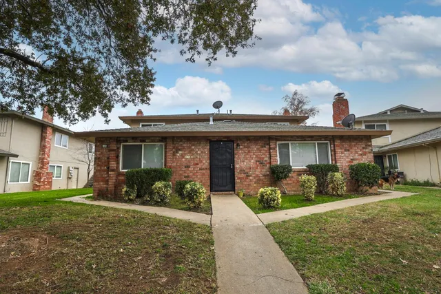 a front view of a house with garden