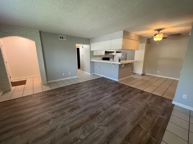 a view of a kitchen with wooden floor