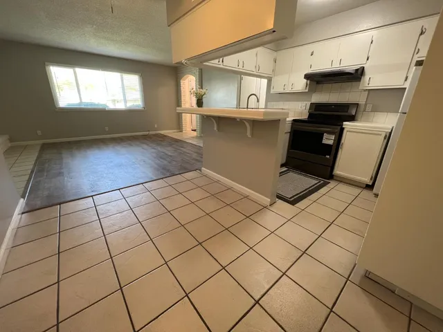 a kitchen with stainless steel appliances a stove a sink and a microwave