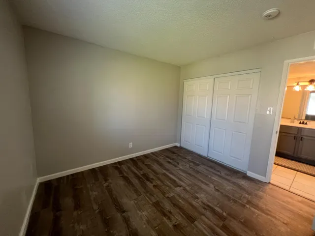 a view of an empty room and wooden floor