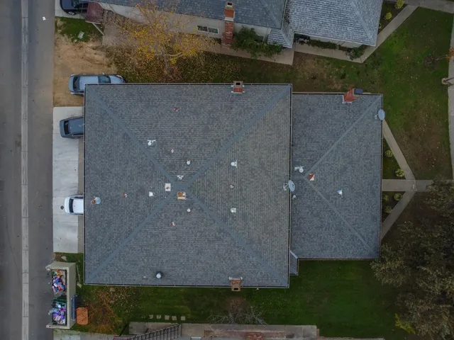 an aerial view of a house with a yard
