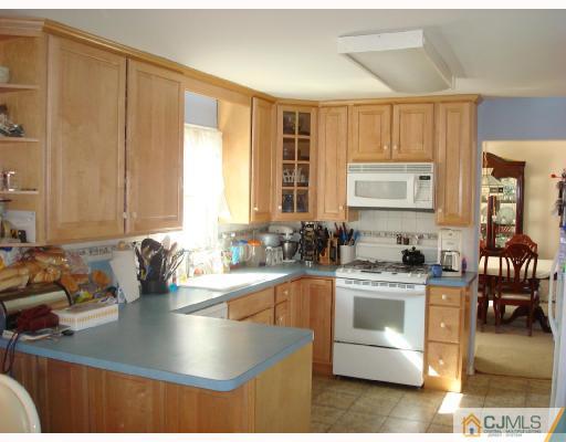 29 Haypress Road Dayton, NJ 08810 - Photo 5 of 10 a kitchen with kitchen island granite countertop a sink stove and cabinets