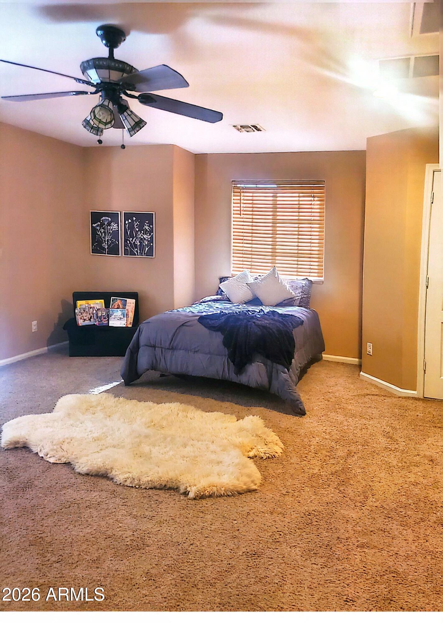 11058 East Cholla Road Mesa, AZ 85207 - Photo 14 of 22 a bedroom with a bed and a chandelier
