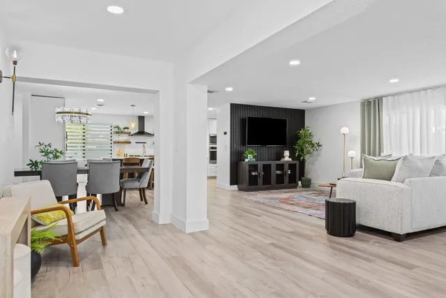 a living room with furniture and a floor to ceiling window