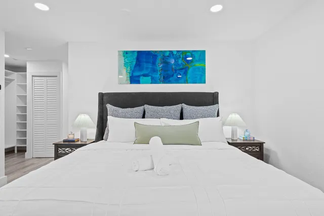 a bedroom with a flat screen tv and a bed