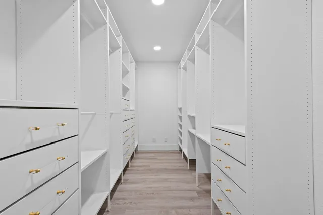 a bathroom with a double vanity sink toilet and shower