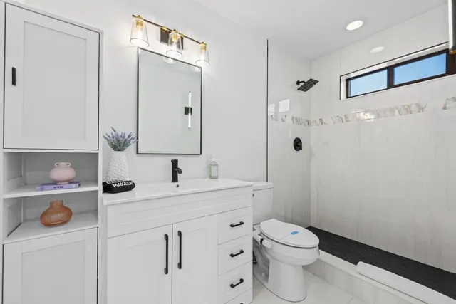 a bedroom with a bed and a night stand