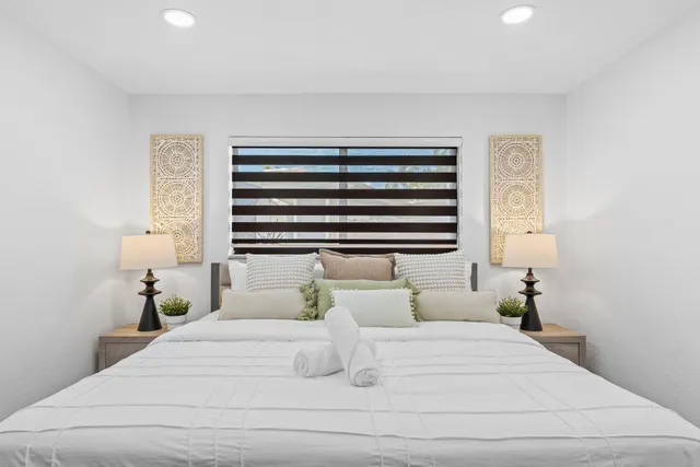 a bedroom with two beds and a window