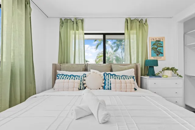 a bedroom with a large bed and a large window