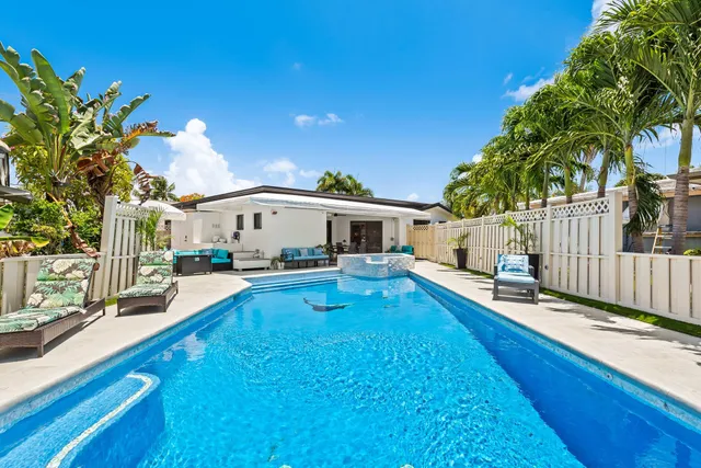 a view of a chairs and table in the balcony