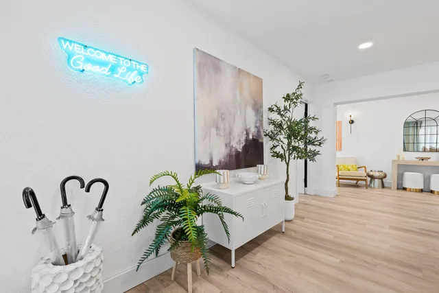 a white cabinet with a vase and flowers on it