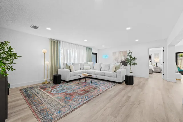 a living room with furniture and a rug