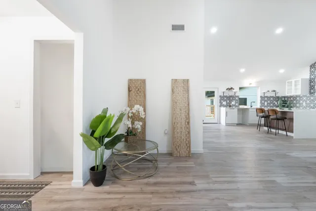 a view of a workspace with furniture and a potted plant